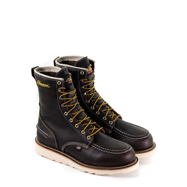 pair of dark brown high top moccasin style boots with yellow and brown laces and white wedge soles