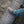 Load image into Gallery viewer, man chain sawing log with foot on log while wearing brown high top moccasin style boot with yellow and brown laces