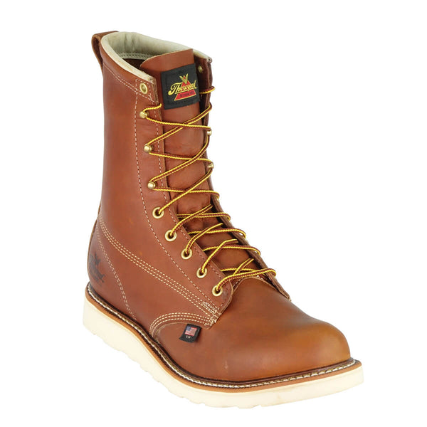 mens brown logger boot with white interior, sticthing, and sole. Black thorogood logo stamped on heel with gold/red laces. front view