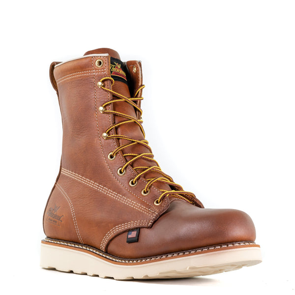 mens brown logger boot with white interior, sticthing, and sole. Black thorogood logo stamped on heel with gold/brown laces.