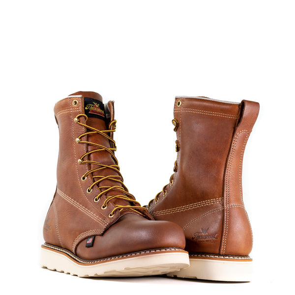 Pair of mens brown logger boot with white interior, sticthing, and sole. Black thorogood logo stamped on heel with gold/brown laces. front and back view