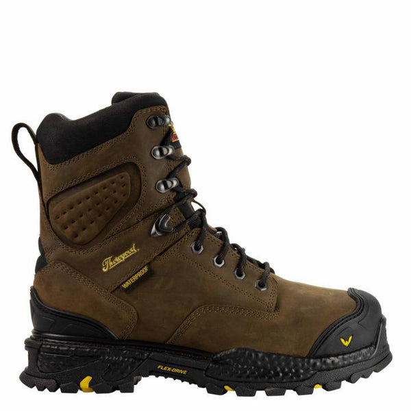 Side view of men's brown leather composite work boot. Black rubber toe, soles, and ankle cuff. Yellow Thorogood logo on tongue and outside ankle.