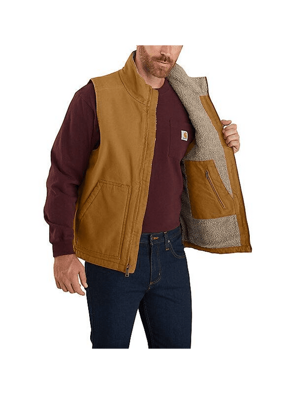 man holding tan Carhartt Sherpa lined vest open over red long sleeve shirt