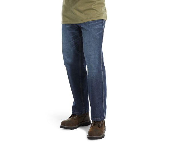 man in dark green shirt waring jeans side view