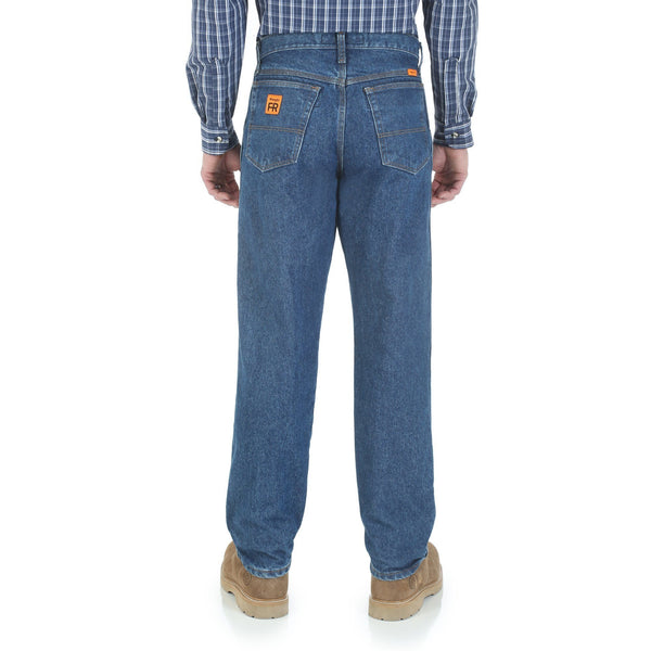 man in blue patterned button up with no belt in blue jeans back view