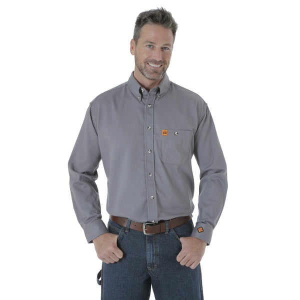 Man with hands in pocket wearing solid grey button up