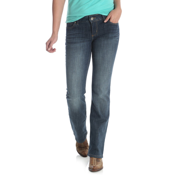 woman in teal wearing faded blue jeans