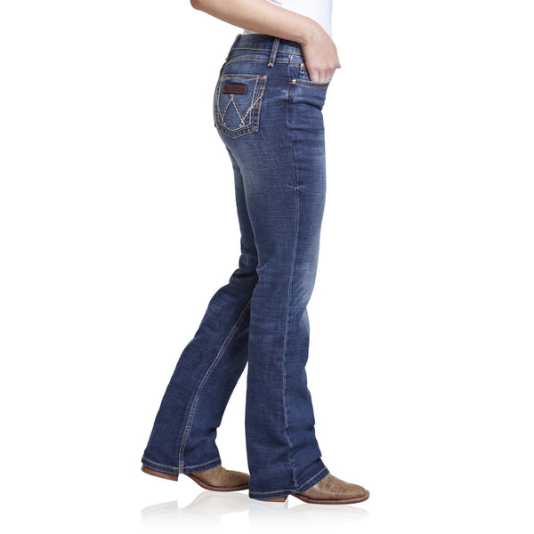 woman in white undershirt in faded blue jeans side angle
