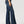 Load image into Gallery viewer, side view of women wearing wide leg blue jeans with tan boots and hand at her side