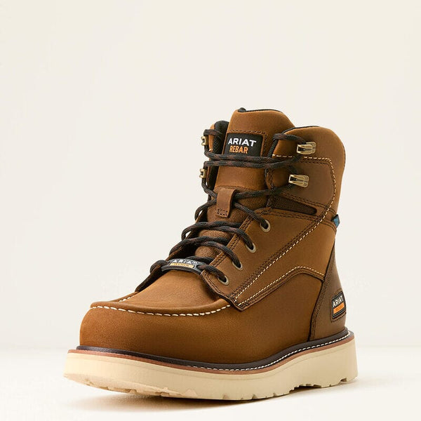 Angled front left side view of a brown work boot with Ariat logo and black laces on a beige background