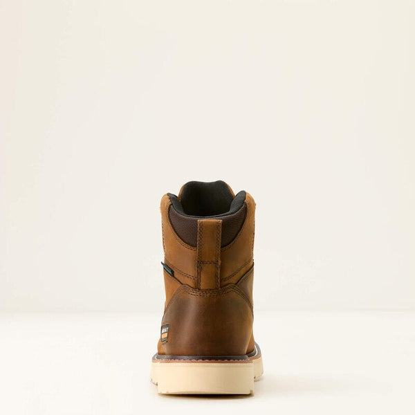 Rear view of a brown leather boot on a beige background