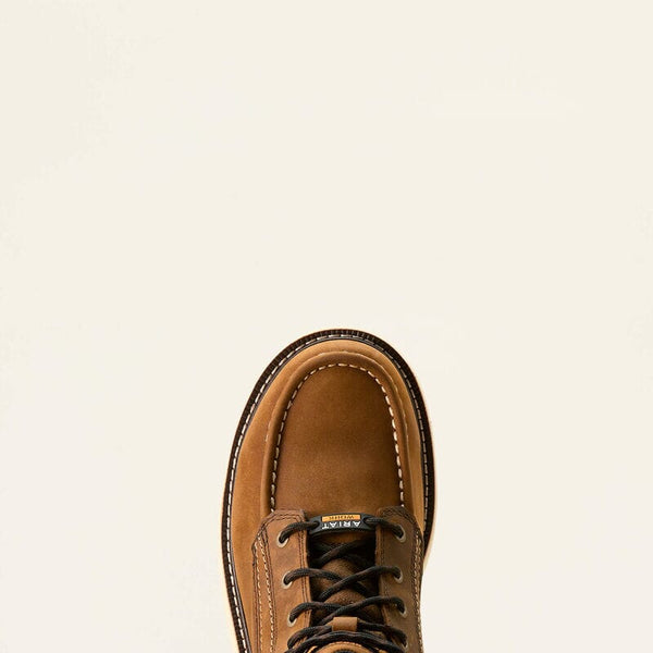 Top down detailed view of a brown leather moc toe work boot on a beige background