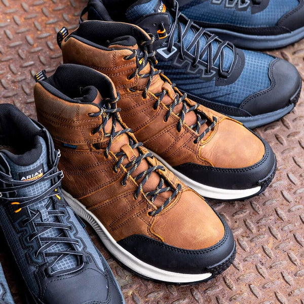 Brown and blue boots with black laces on a textured metal surface