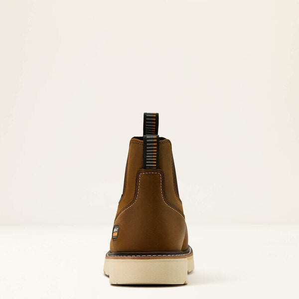Rear view of brown leather chelsea boot with a white sole on a beige background