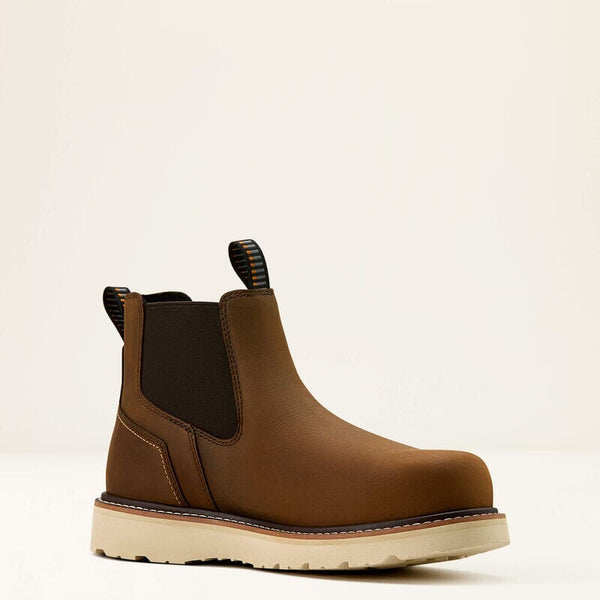 Brown Chelsea work boot on a beige background