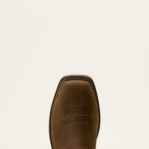 Detailed view of a brown leather boot wide square toe with stitched design on a beige background