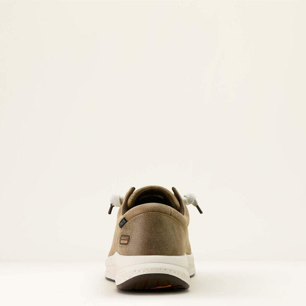 Rear view of a brown shoe with white sole on a light beige background