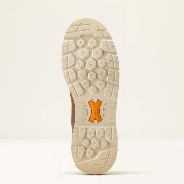 Close-up of a beige work boot sole with a brand logo on a light beige background