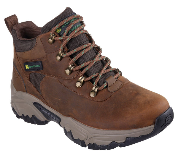 A brown, lace-up, mid-top men's work boot with a Skechers x John Deere logo, waterproof upper, and a Goodyear rubber outsole.