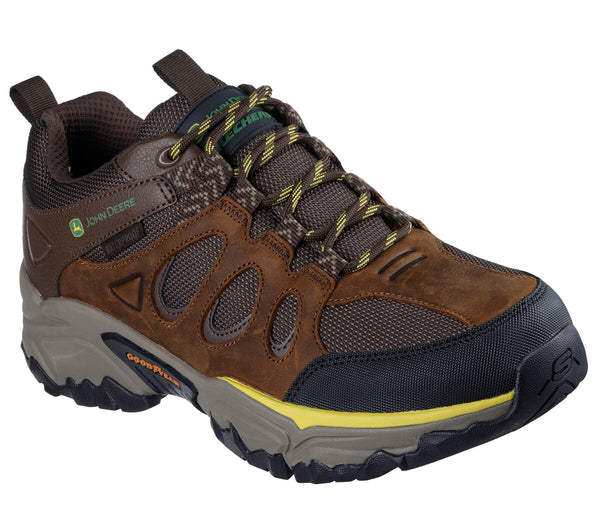 A brown Skechers John Deere low-top outdoor work boot with lace-up leather and mesh upper, synthetic overlays, and a rubber outsole.