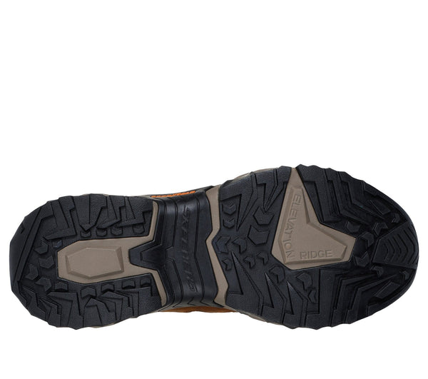 Black and tan sole of outdoor work shoe.