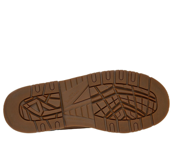 Bottom view of the tan sole of a work boot with tread pattern.
