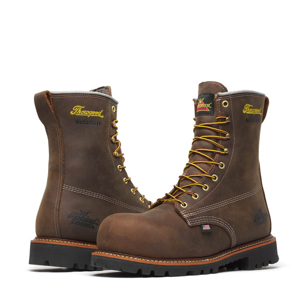 Pair of brown leather boots with yellow laces on a white background