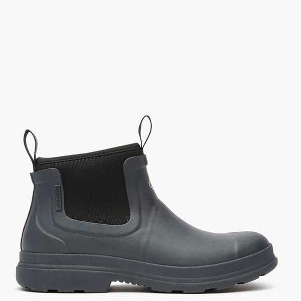 Black rubber boot with a black sock on a white background