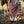 Load image into Gallery viewer, Person wearing a red plaid skirt and beige boots standing next to a horse in a natural setting.
