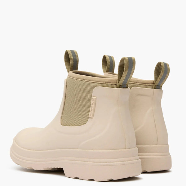 Rear view of a pair of beige rubber boots with elastic sides on a white background
