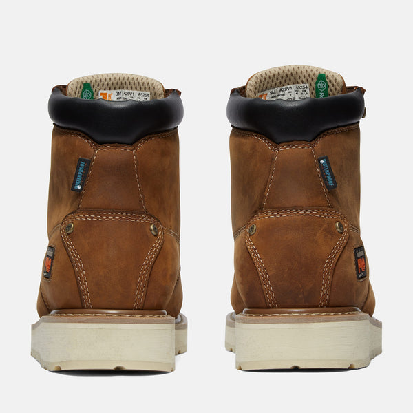 Back view of pair of brown work boots with visible stitching on a white background