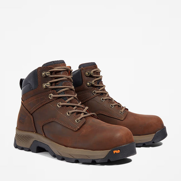 A pair of brown Timberland work boots with composite toes and rubber soles, featuring a lace-up closure.