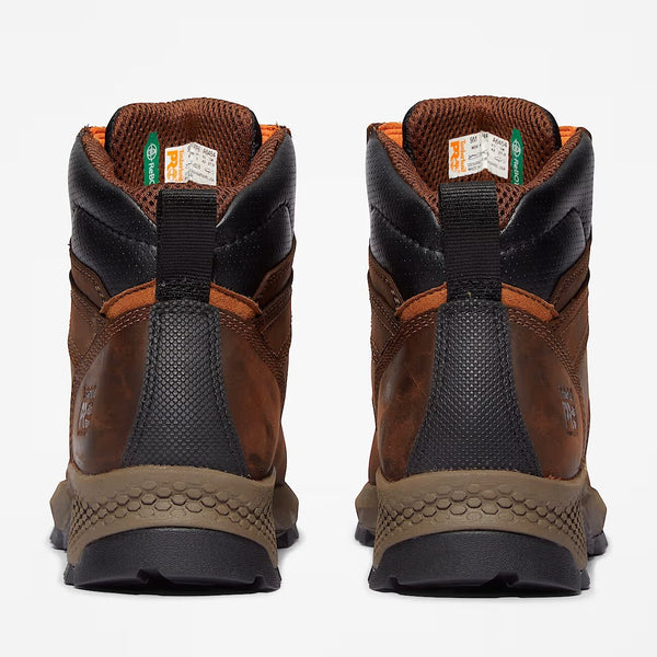 Pair of brown and black boots on a white background