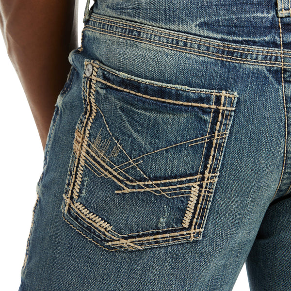 close up of men's medium wash distressed jeans back left pocket with ivory stitching design