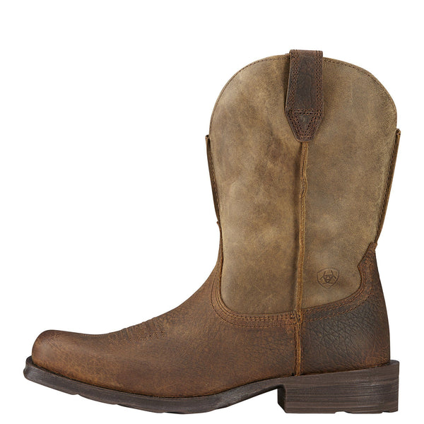 side view of cowboy boot with a distressed light brown shaft and a darker brown vamp