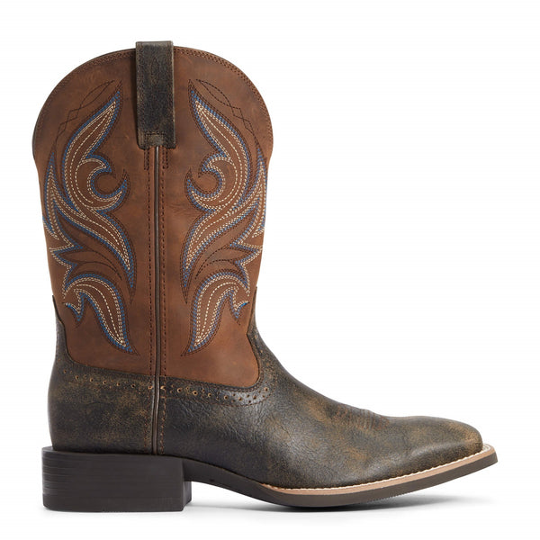 side view of Two toned brown and black cowboy boots with white and blue embroidery