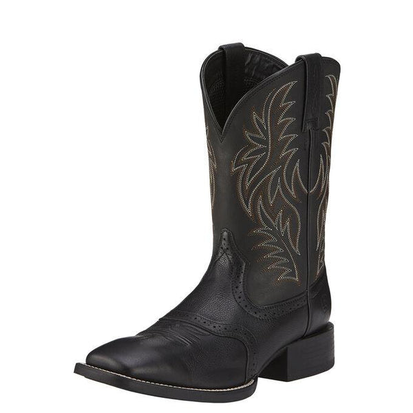 side view of black cowboy boot with white and light brown embroidery