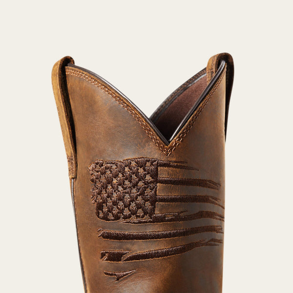 close up view of embroidered rugged American flag on brown distressed western work boot