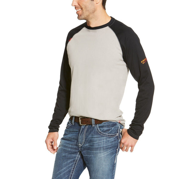 man wearing a grey and black baseball tee with black sleeves and blue jeans