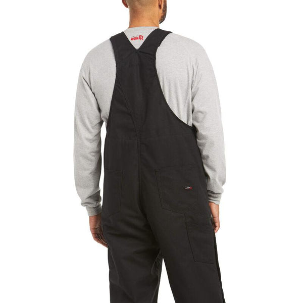 back view of African American man wearing black bib overalls and a grey shirt