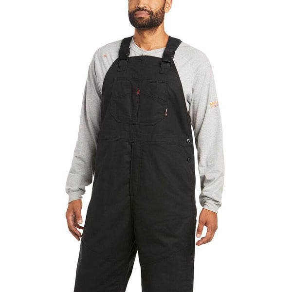 African American man wearing black bib overalls and a grey shirt