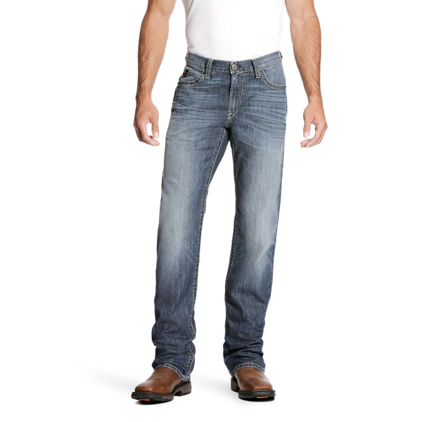 man wearing distressed faded blue jeans and a white tshirt 
