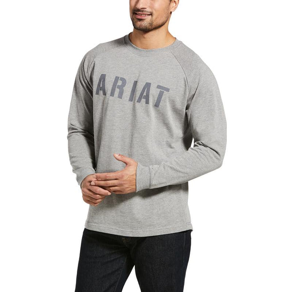 man wearing a grey long sleeve shirt with the word Ariat in stencil across the chest