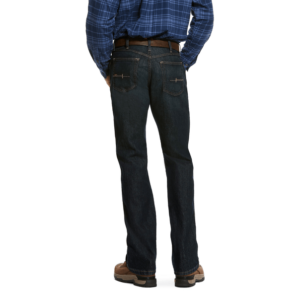 back view of a man wearing dark blue jean and a blue plaid shirt 