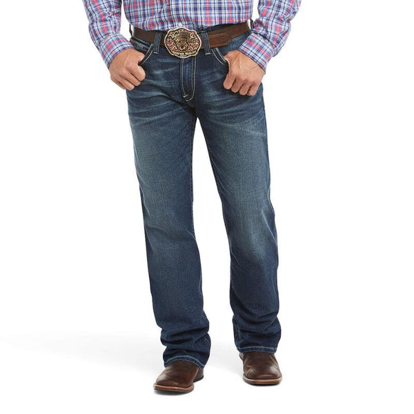 man wearing blue jeans and a plaid shirt 