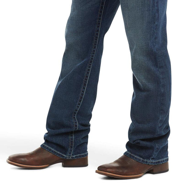 lower legs wearing blue jeans and cowboy boots