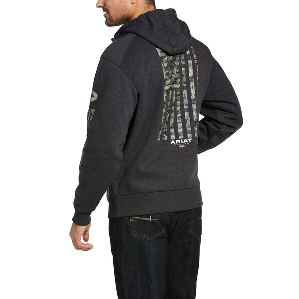 back view of man wearing a zip up jacket with a camo American flag on the back