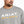 Load image into Gallery viewer, chest view of Man wearing grey sweatshirt with Ariat written on the front and a yellow dotted line pattern underneath 

