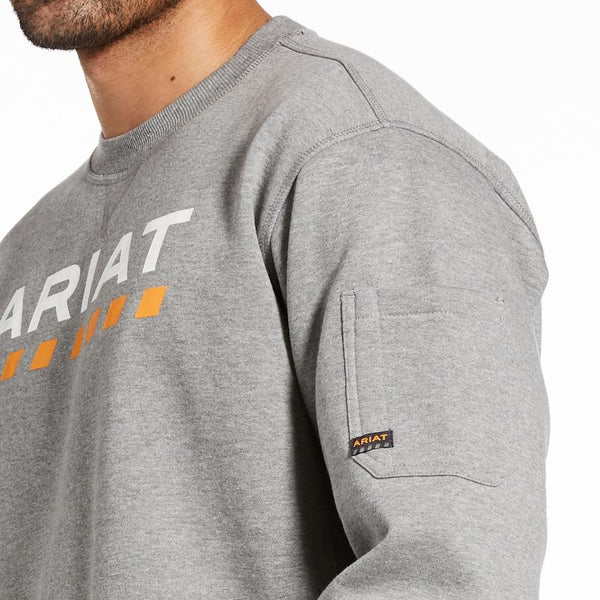 side view Man wearing grey sweatshirt with Ariat written on the front and a yellow dotted line pattern underneath 
