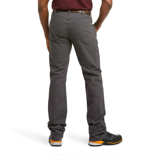 back view of man wearing grey work pants and black and orange work shoes